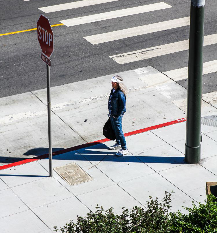 Woman waiting for bus in the sun